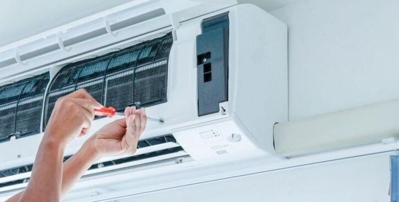 A trained technician installing an air conditioner